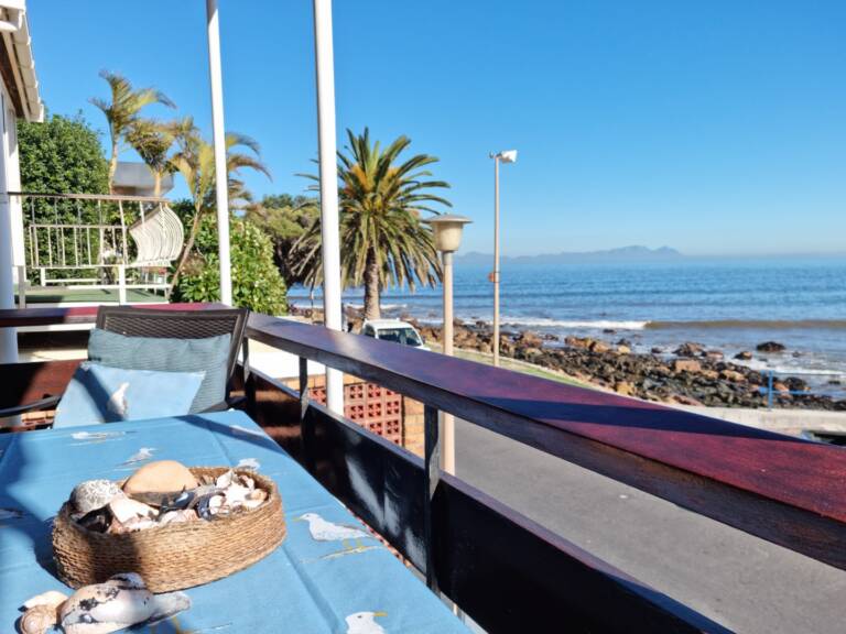 bikini beach holiday home gordons bay 27 balcony dining with beach view 768x576