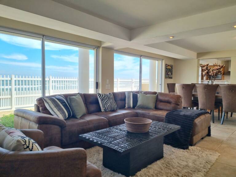 paradise tide gordons bay 06 living room with dining and sea view 768x576