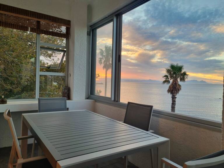 top flat gordons bay 28 enclosed veranda with dining table 768x576