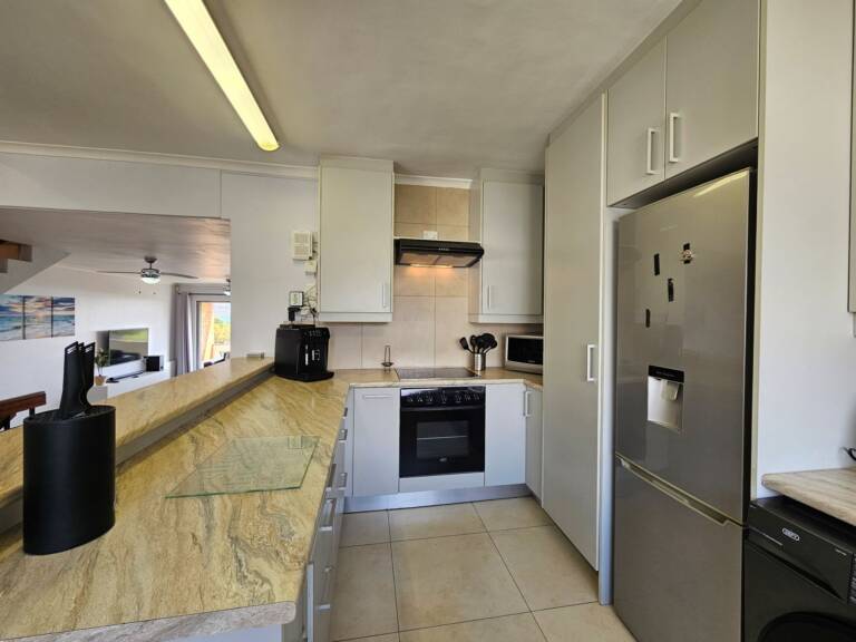 4 la corniche gordons bay 08 open plan kitchen with dining table 768x576